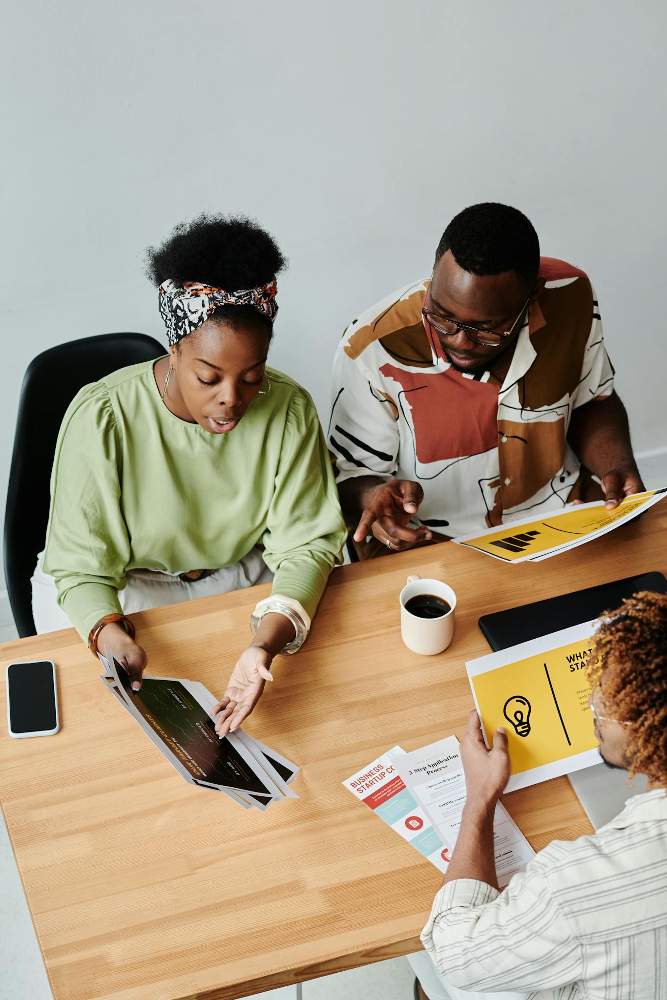 Top view of colleagues in a dynamic business meeting discussing ideas.